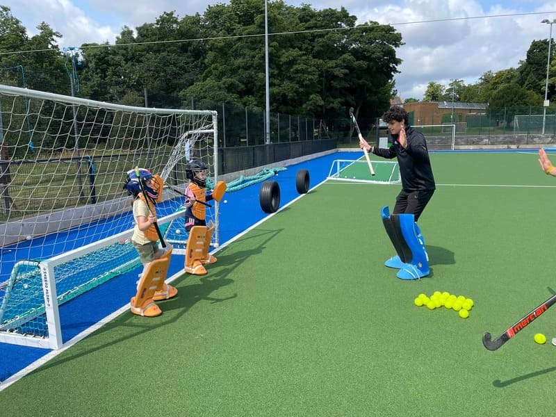 Young children learning how to play hockey